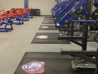 Grand Oaks Custom Weightlifting Platforms & Logos | closeup view of 12 custom weightlifting platforms with logos in the grand oaks high school weight room