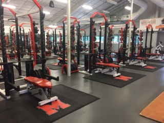 Mineola High School Weight Room mineola high school weight room with strength racks, rubber weightlifting platforms and school logos